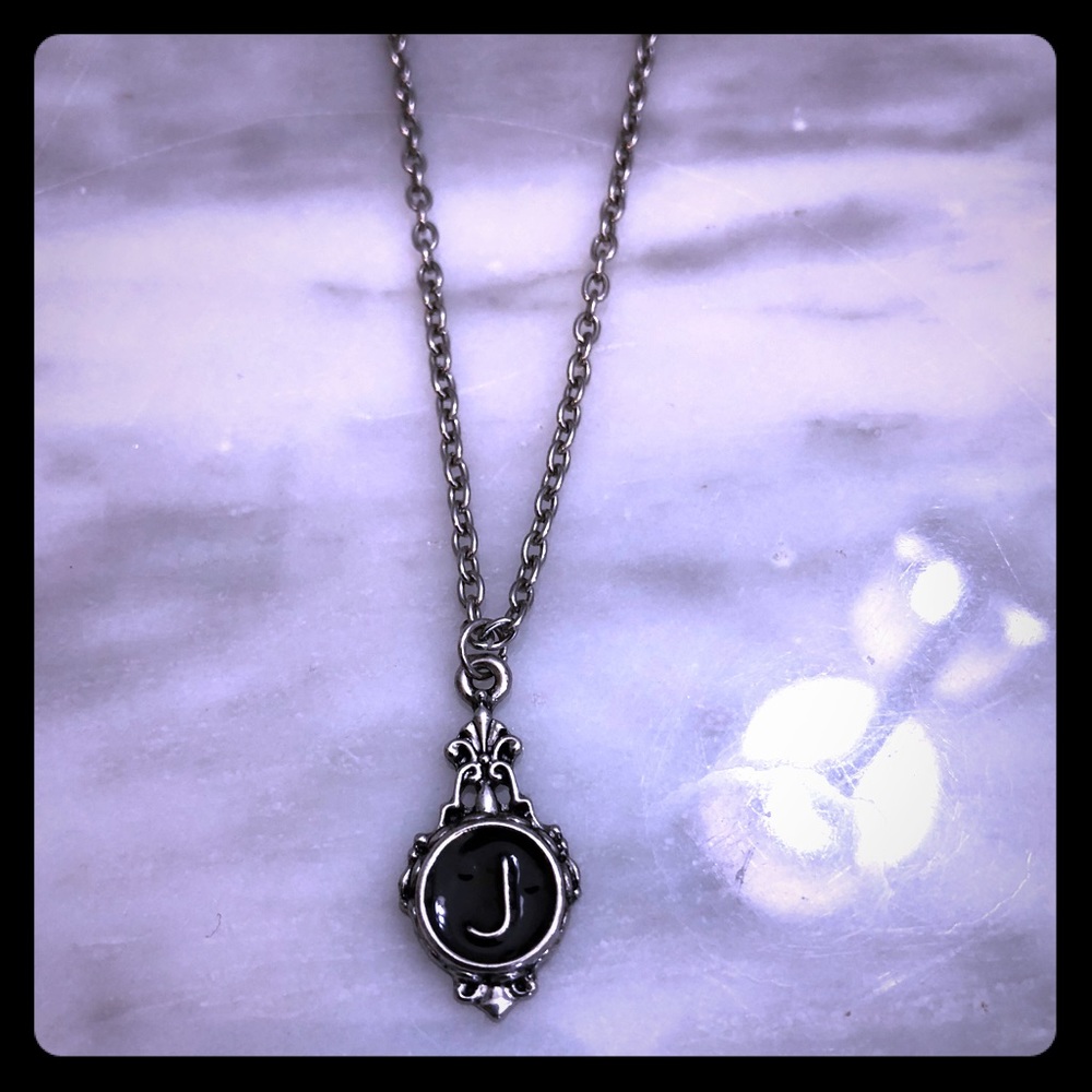 Necklace with a J on it.